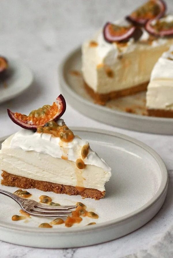 White Chocolate and Passion Fruit Cheesecake on a white plate in slices.
