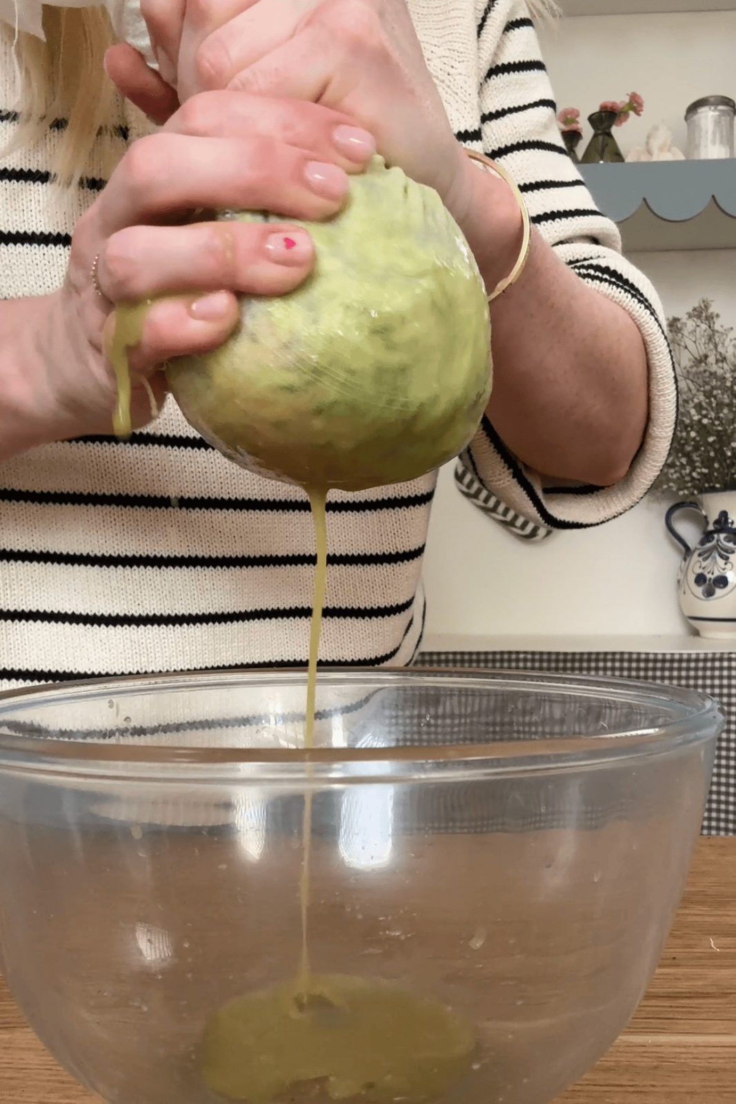 squeezing liquid out of courgette and potato.