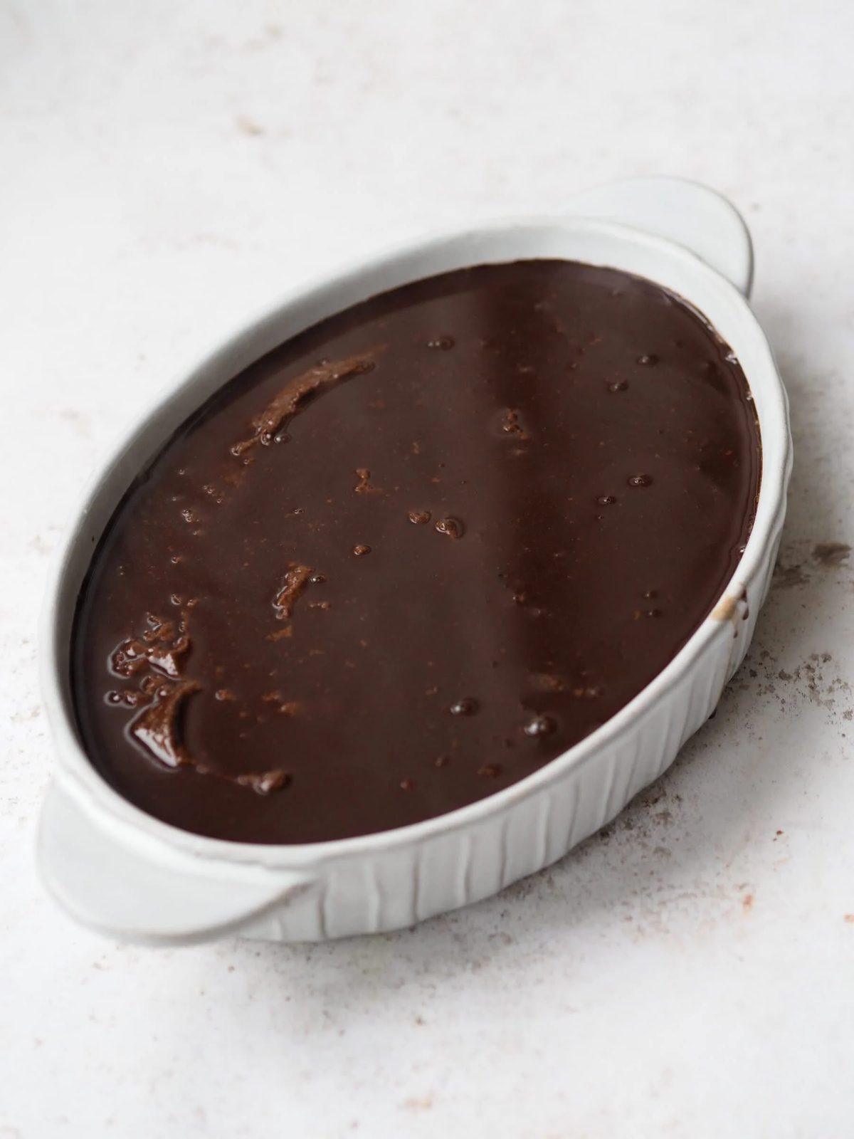 Self Saucing Chocolate Pudding in a white baking dish before baking.