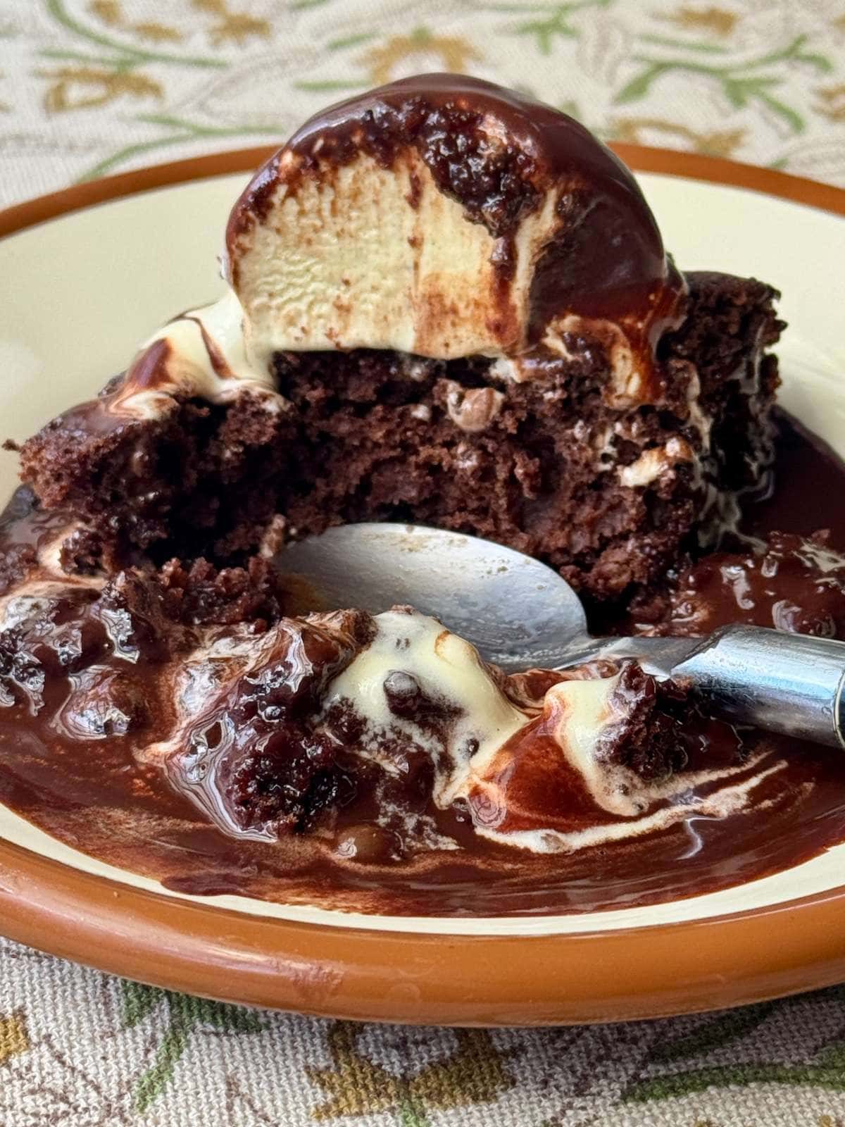 self saucing chocolate pudding on a plate with ice cream.