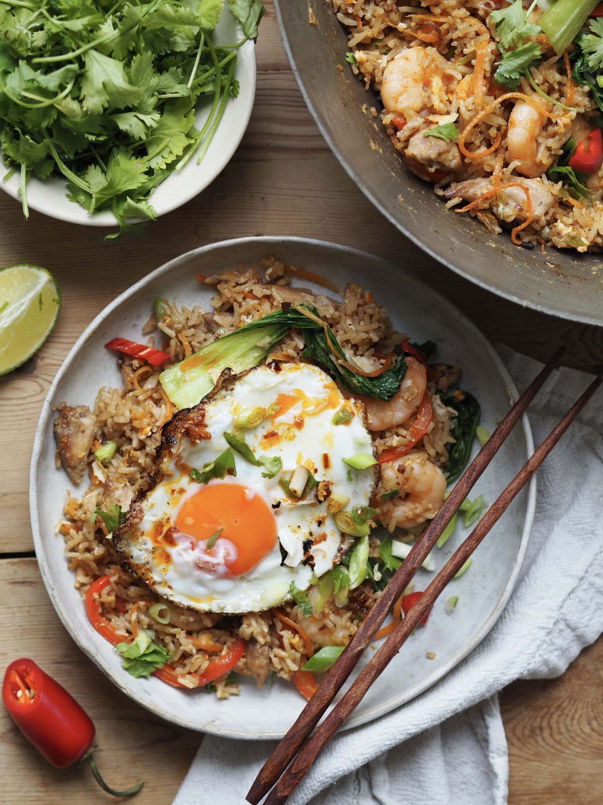 Bowl of Shrimp and Chicken Fried Rice on table with chopsticks.