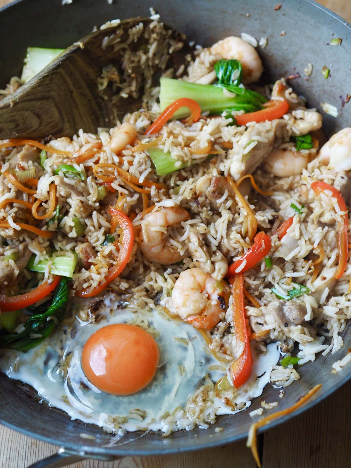 Egg frying in chicken and rice stir-fry.