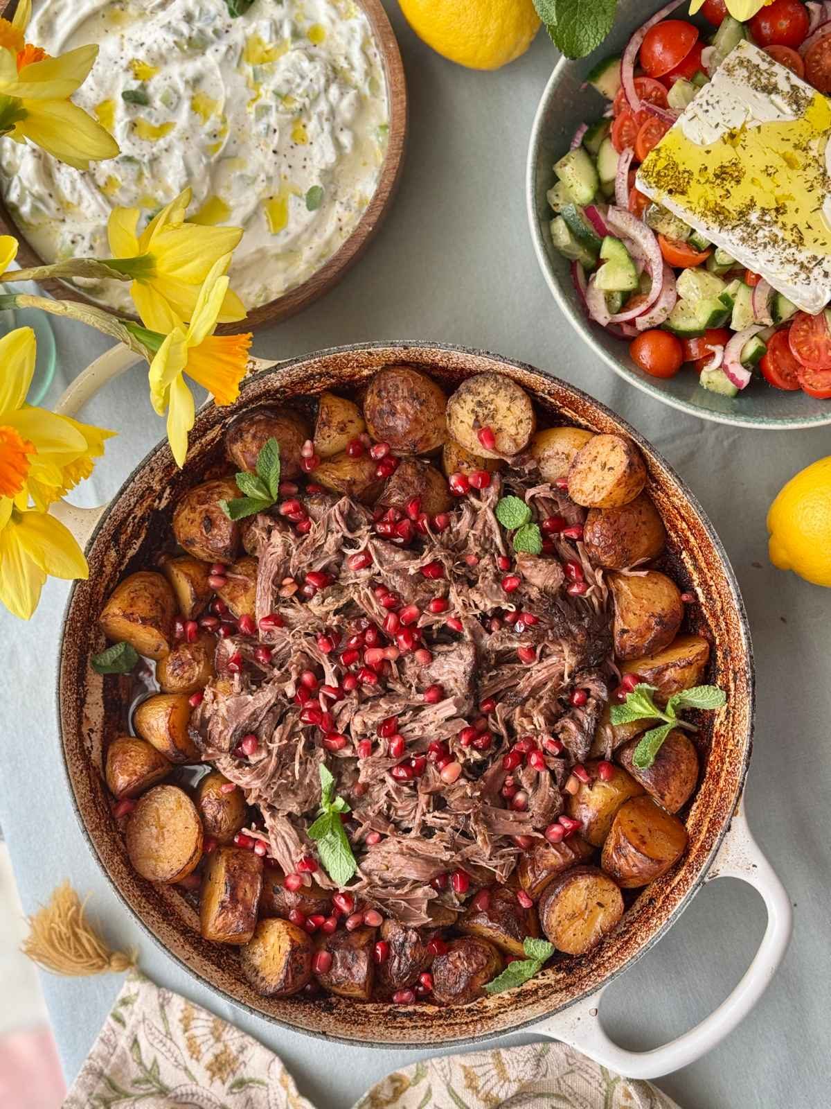 slow cooked lamb with potatoes in a tray.