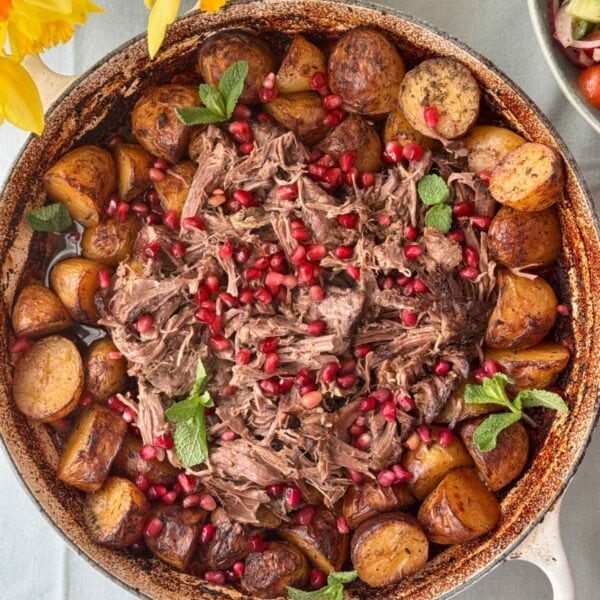 slow cooked lamb with potatoes in a tray.