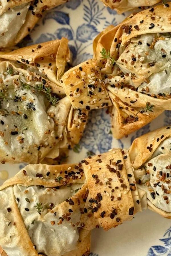 spinach feta filos bows on greaseproof paper.