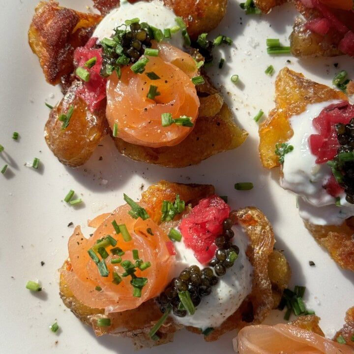 Smashed Potatoes with Crème Fraîche on white plate.
