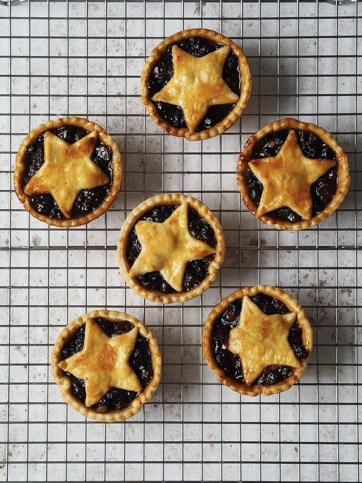 Mince pies on a cooling rack.