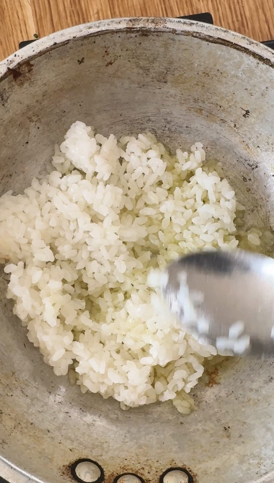 Sauteing rice in pan with olive oil.