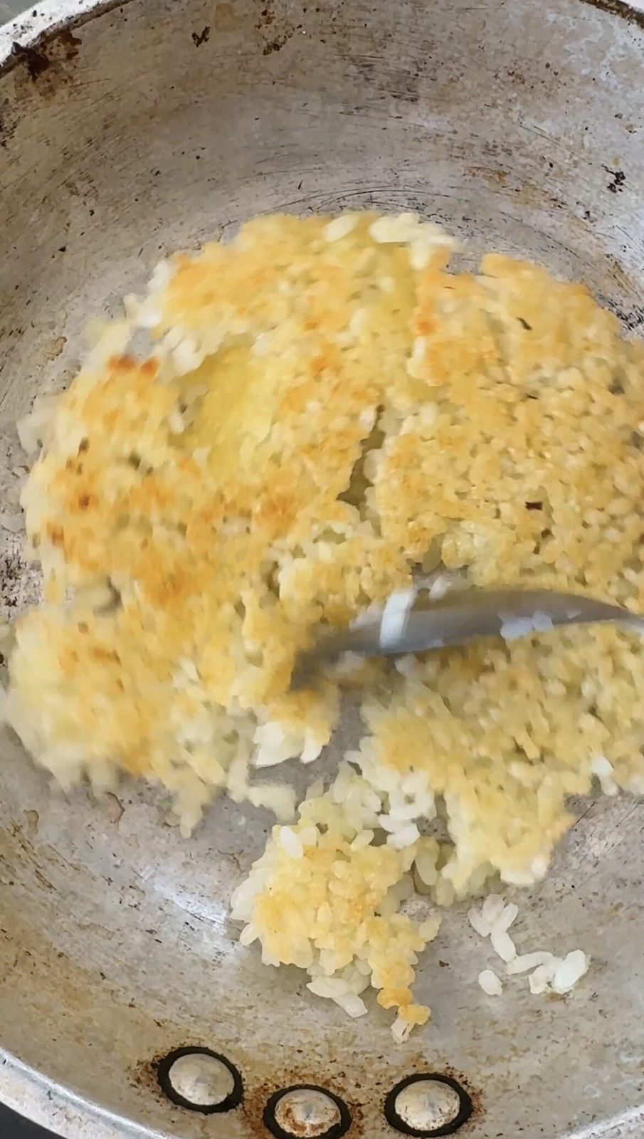 Making crispy rice in small pan.