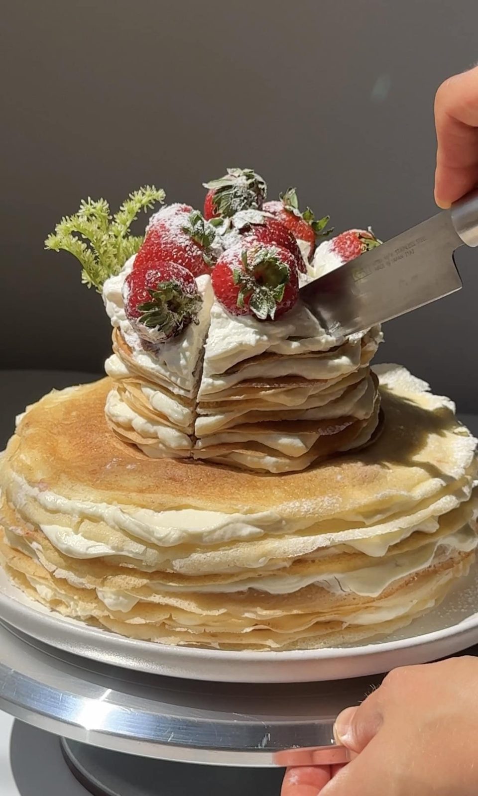slicing mille crepe cake.