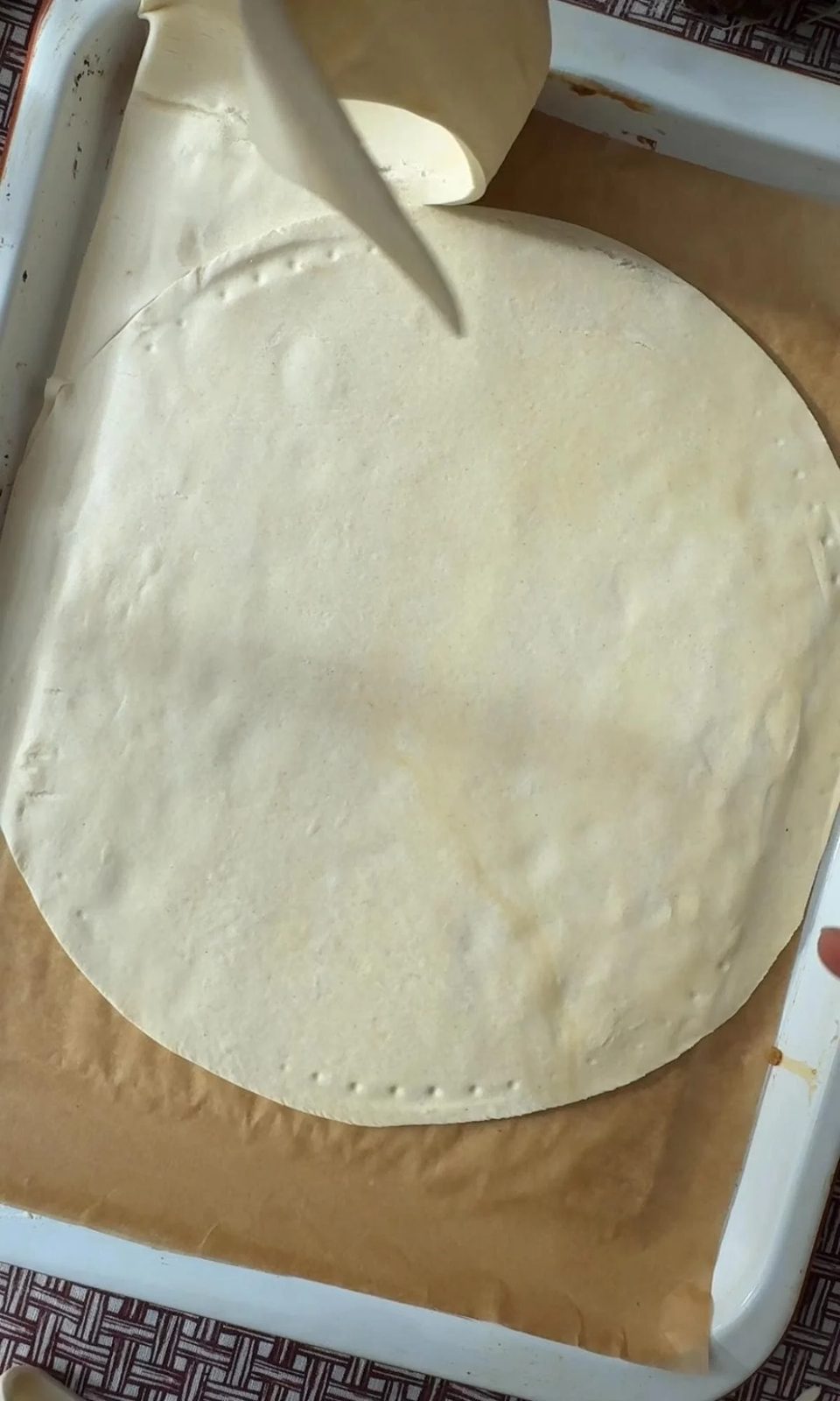 cutting out a circle of pastry.
