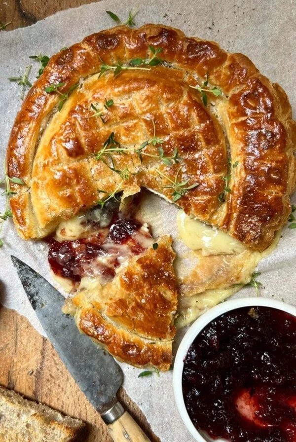 Slicing the Camembert en Croute (Whole Baked Camembert in Puff Pastry).