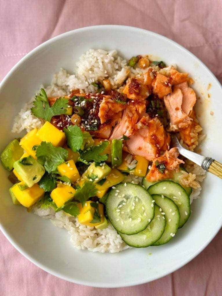 Teriyaki salmon bowl with mango avocado salsa and rice.
