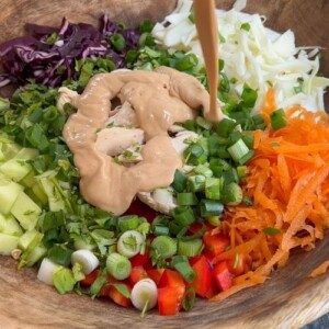thai peanut salad in wooden bowl