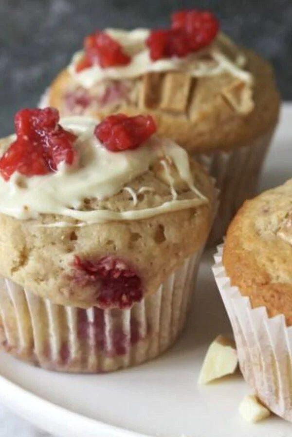 raspberry white chocolate muffin on a white plate.