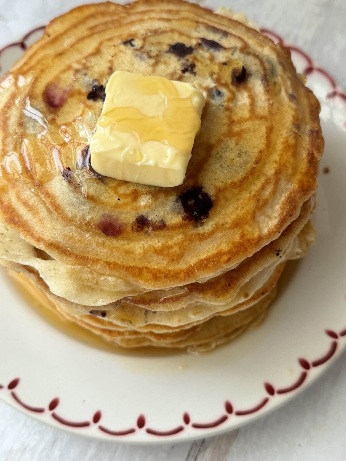 A stack of pancakes with no baking powder on a white plate.