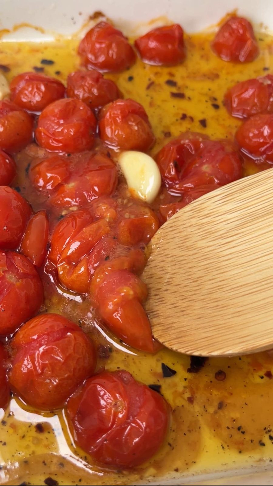 using the back of a spoon to mash the sauce together.
