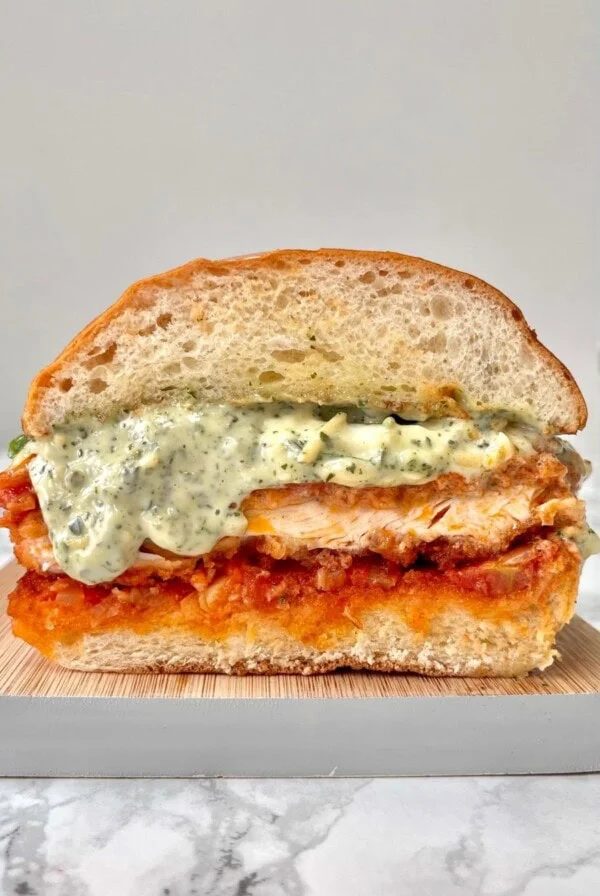 chicken parm sandwich cross section on a marble counter