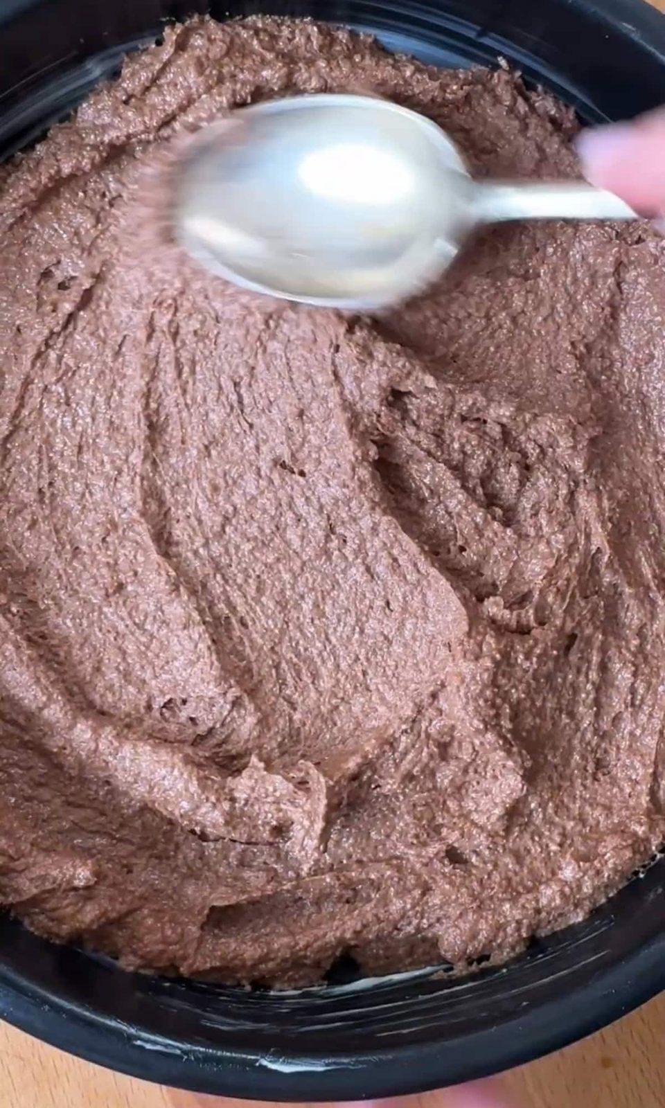 smoothing torta caprese batter into cake tin.