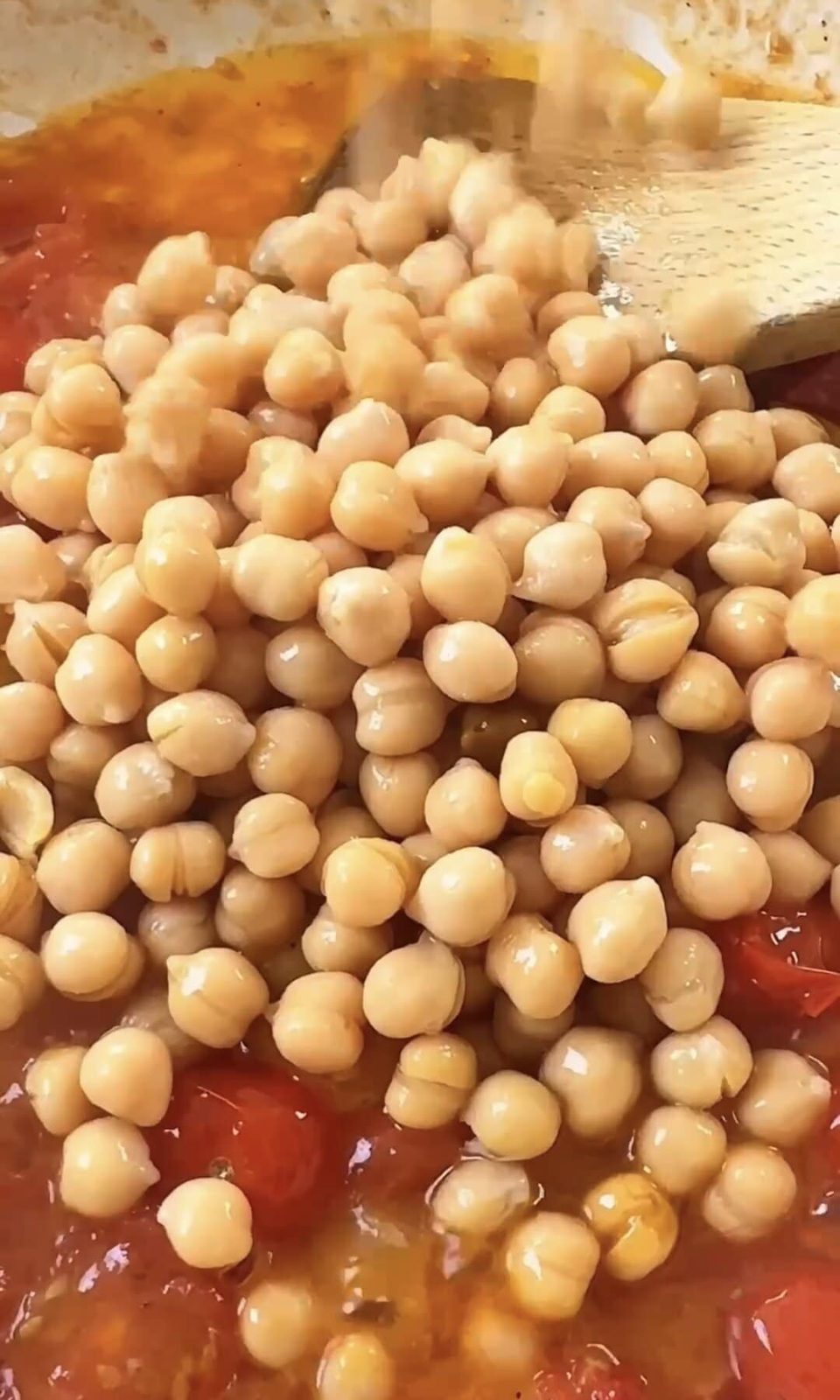 adding chickpeas to the pasta.