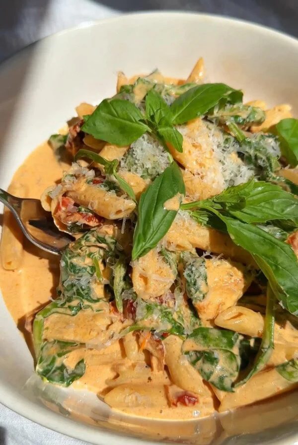 marry me chicken pasta in a white bowl close up.