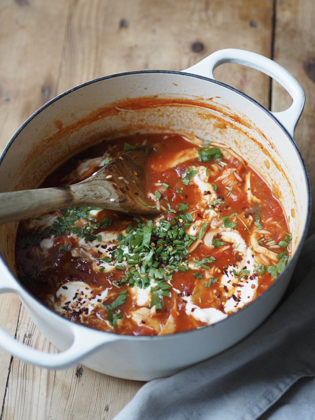 Turkey and Rice Soup in apot with a wooden spoon.