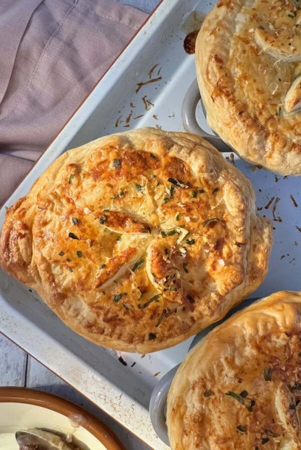Mini chicken pot pies on baking sheet.