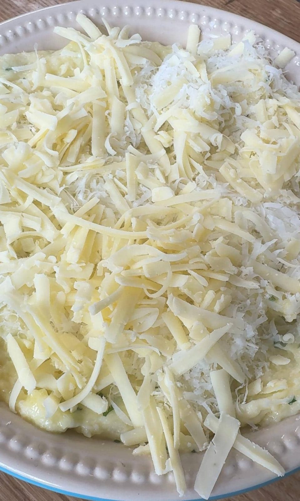 topping the mashed potatoes with cheese before baking.