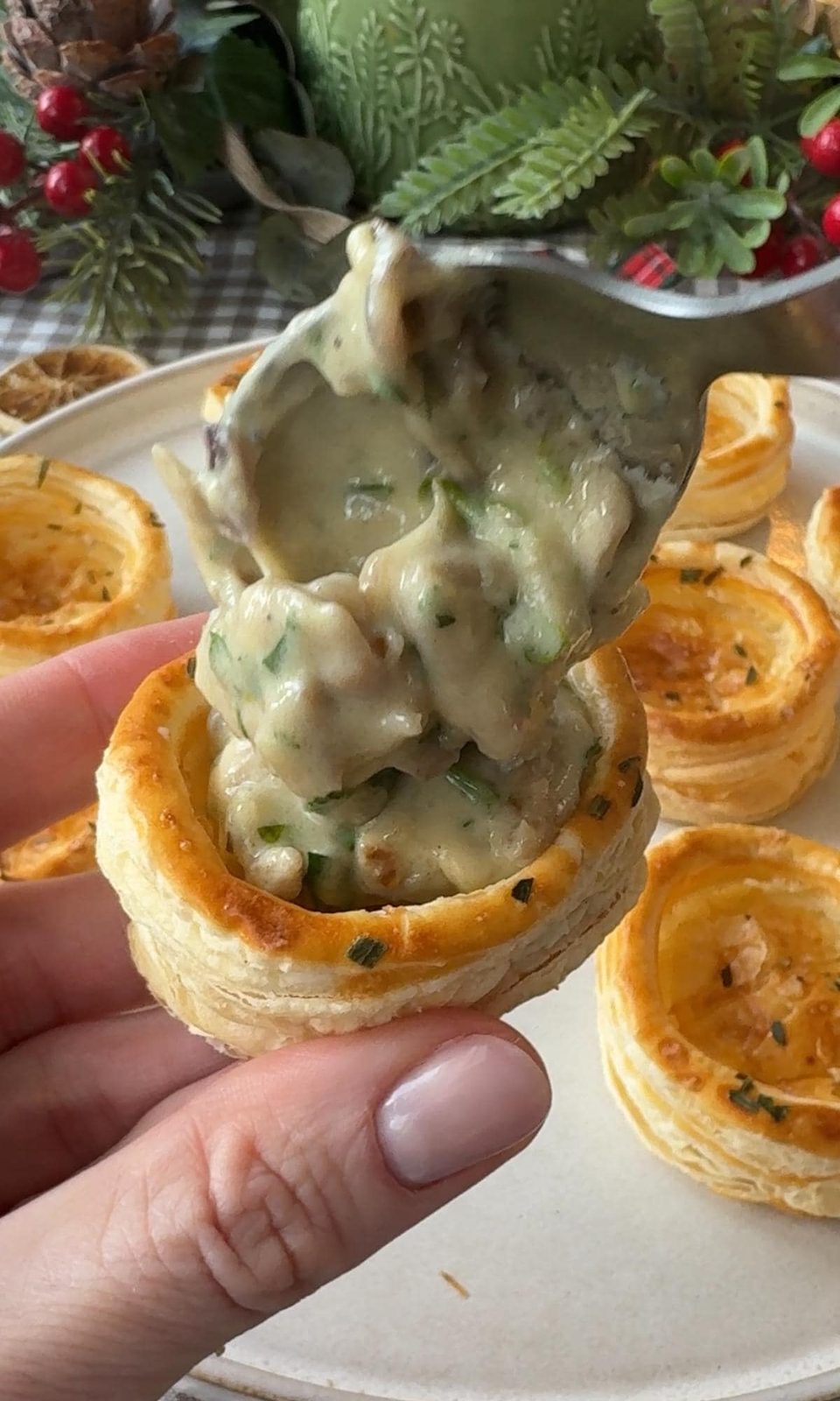 spooning the filling into the vol au vents.