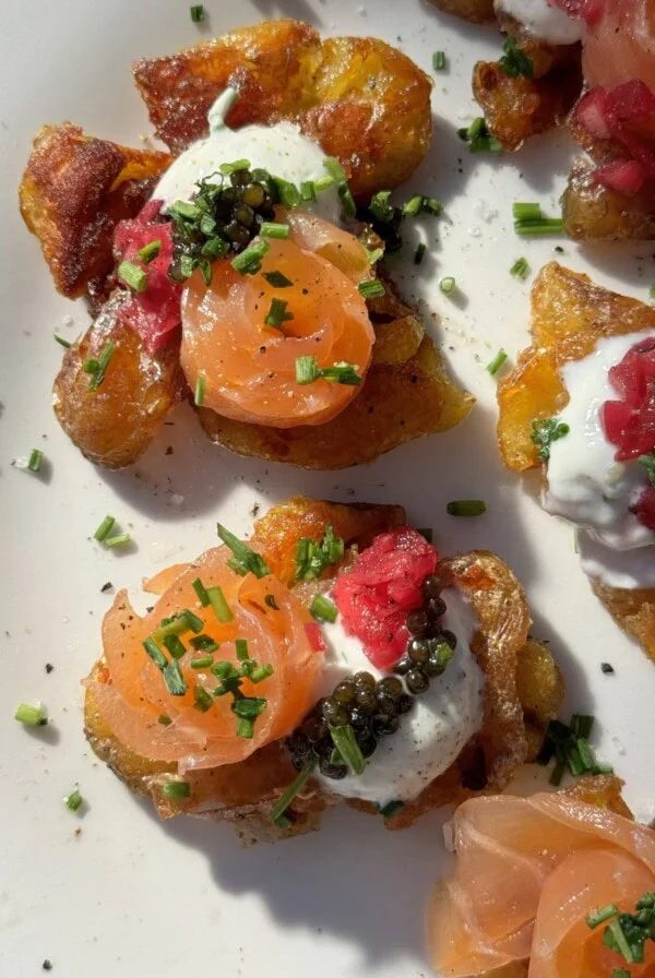 Smashed Potatoes with Crème Fraîche on white plate.