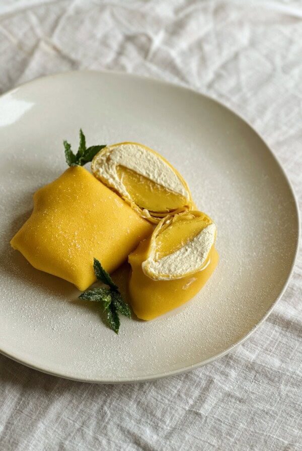 folded mango pancakes on a white place