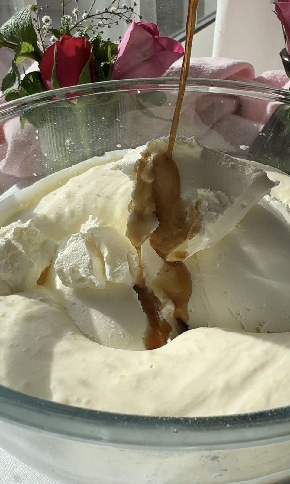 Adding vanilla to the bowl of whipped mascarpone and cream.