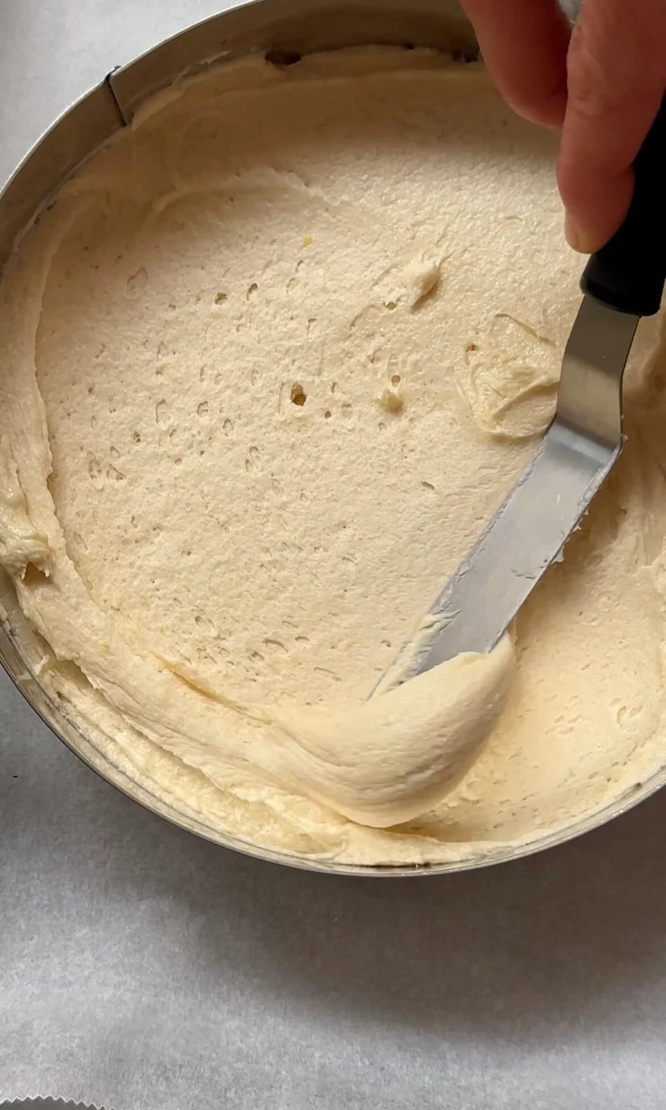 smoothing cake batter into the tins.