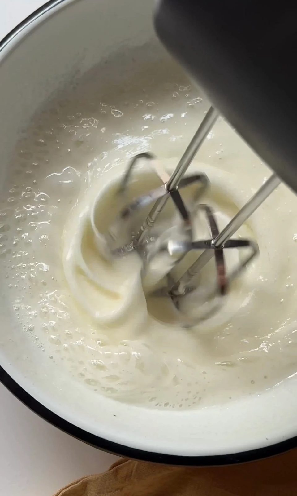 beating sugar and egg whites together.