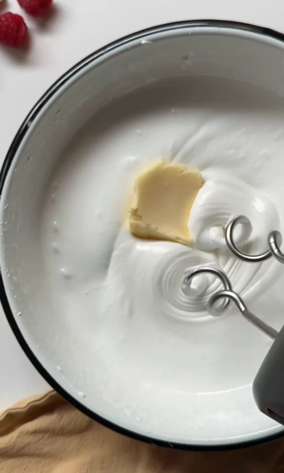beating butter into the swiss buttercream.