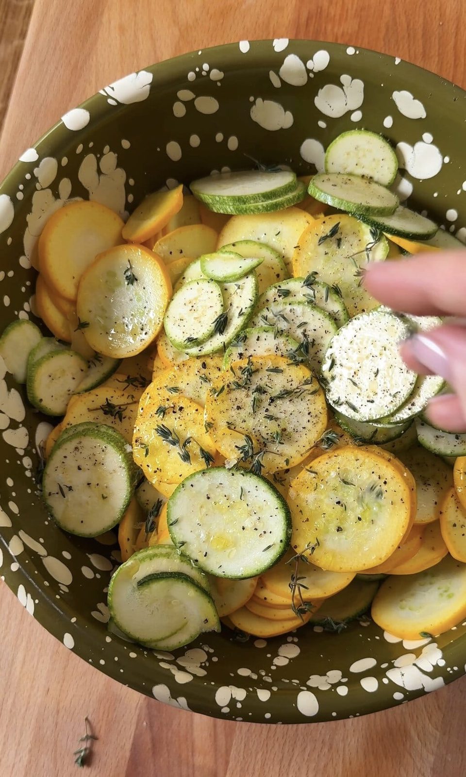 seasoning zucchini with thyme and salt.