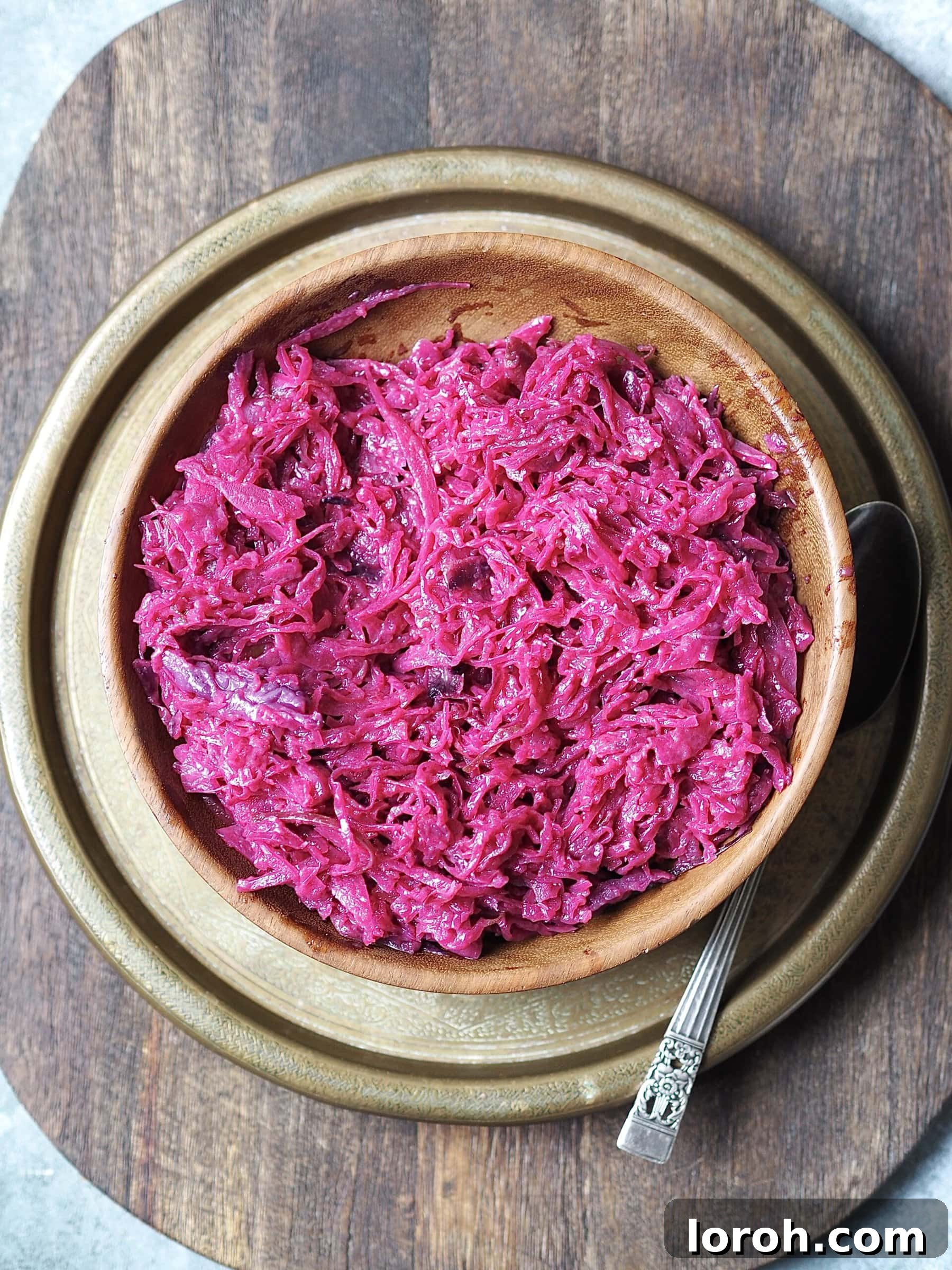 A beautifully presented wooden serving bowl filled with sweet and tangy braised red cabbage.
