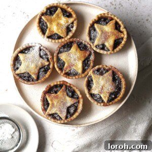 Plate of mince pies dusted with icing sugar.