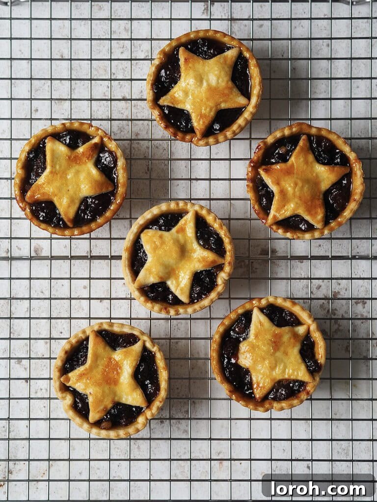 Mince pies cooling on a wire rack after baking.