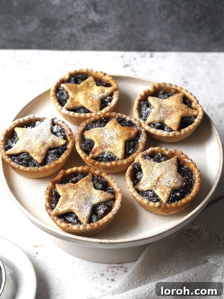 Cake stand of star topped mince pies, beautifully arranged.
