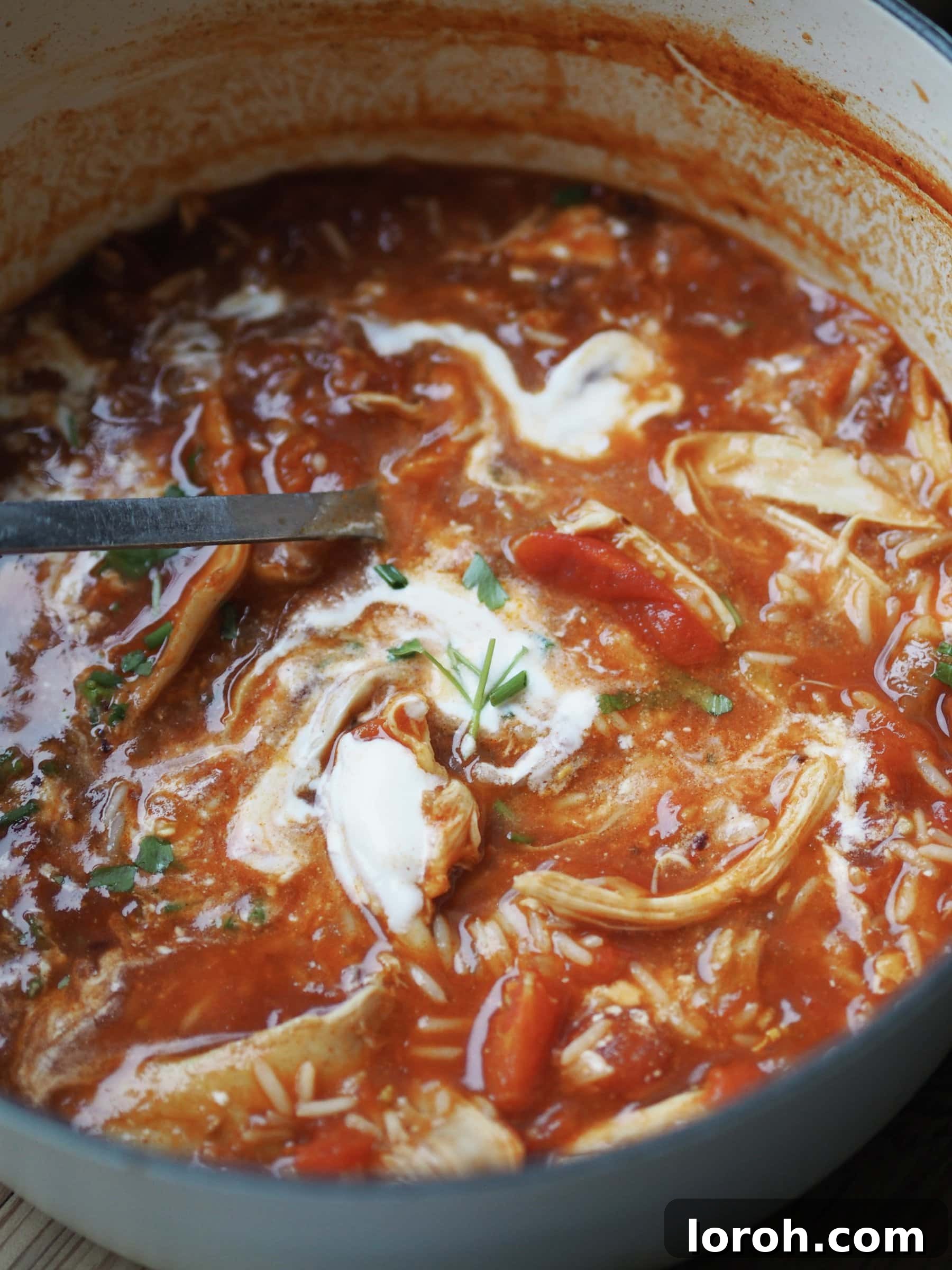 Stirring in creamy crème fraîche into the hot Turkey and Rice Soup, adding richness and a subtle tang.