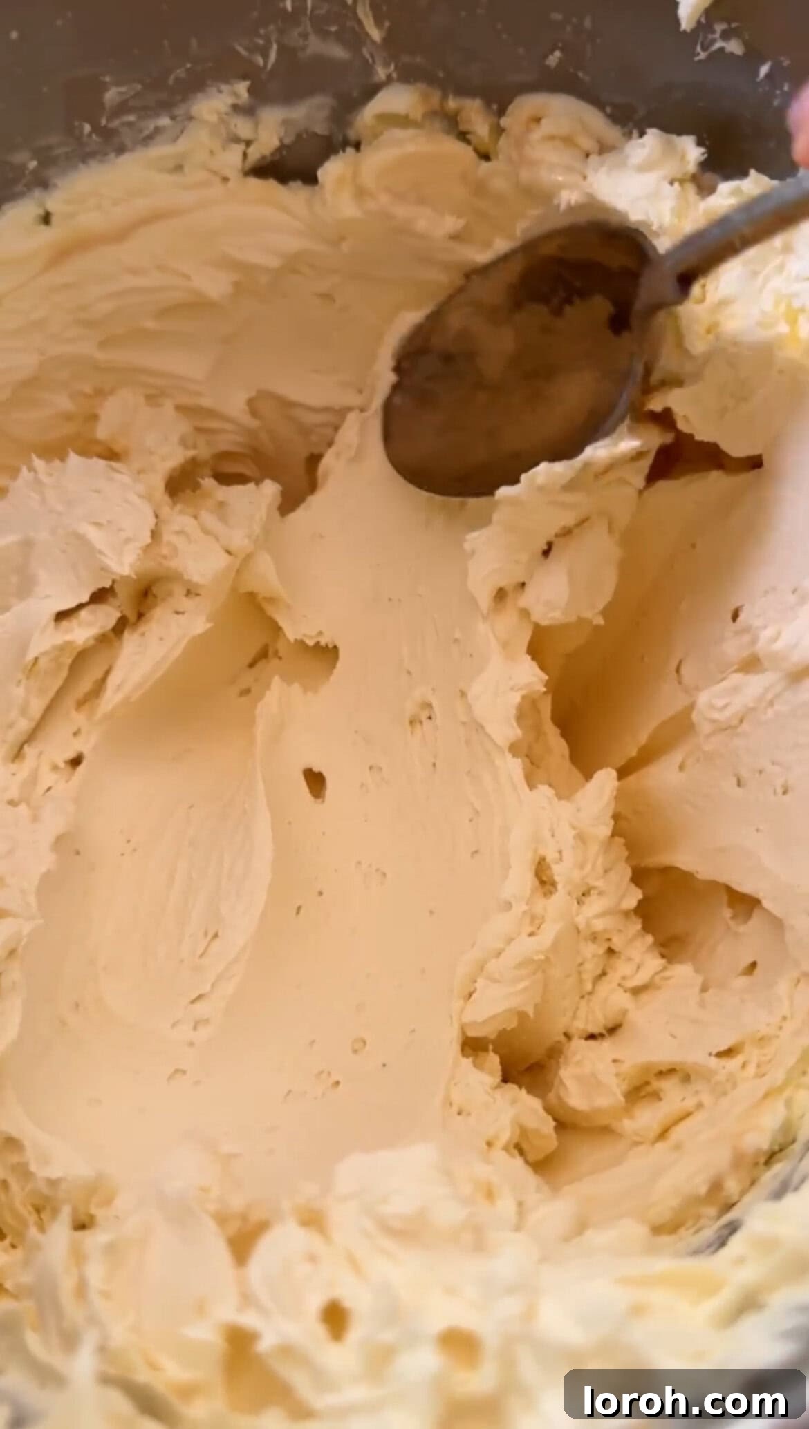 Whisking the mascarpone mixture until thick and creamy.