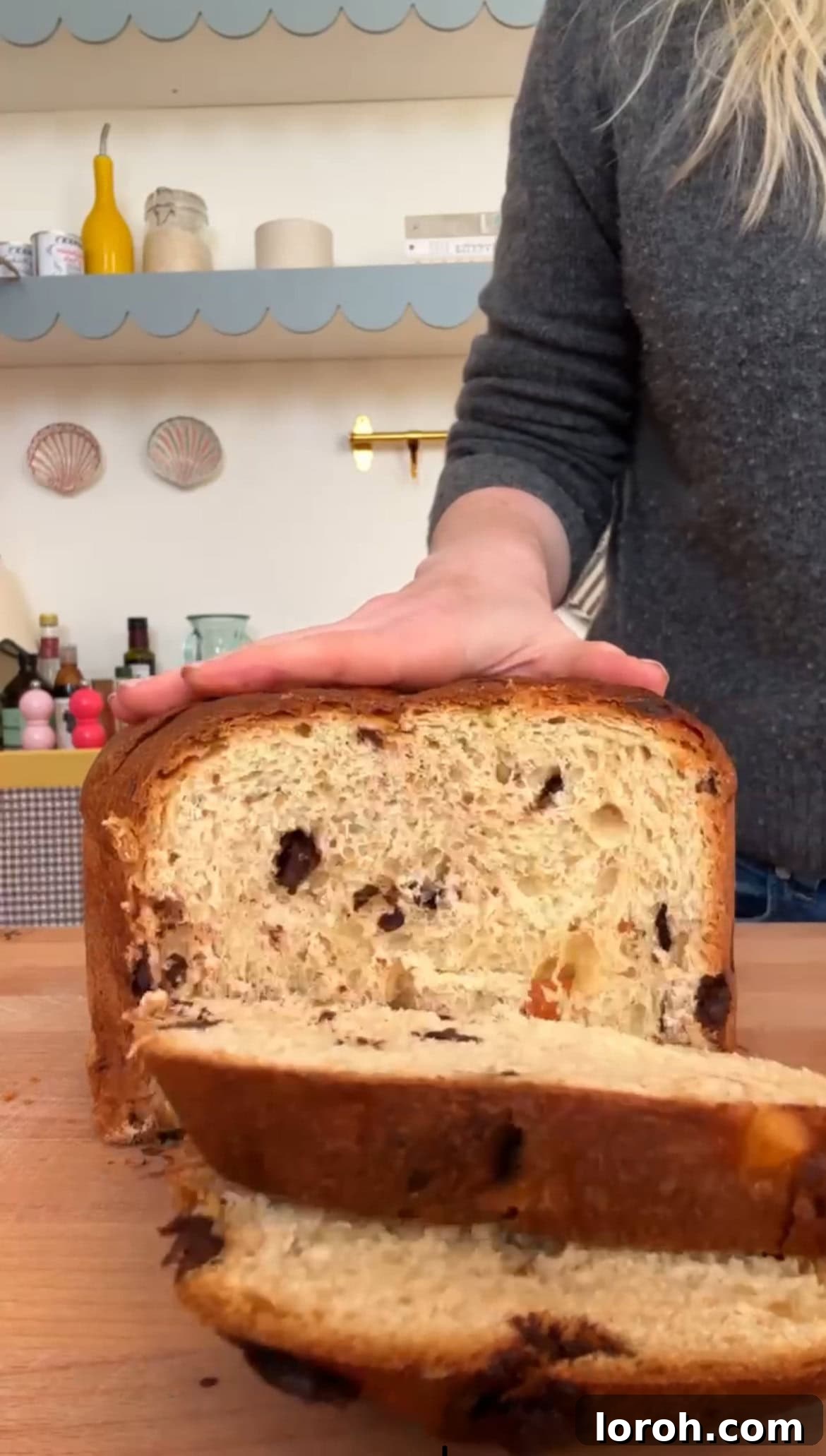 Slicing the panettone into even pieces with a bread knife.