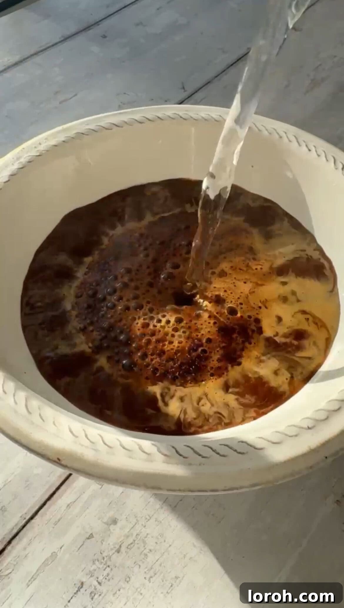 Mixing instant coffee granules, Baileys, and boiling water for the panettone soak.