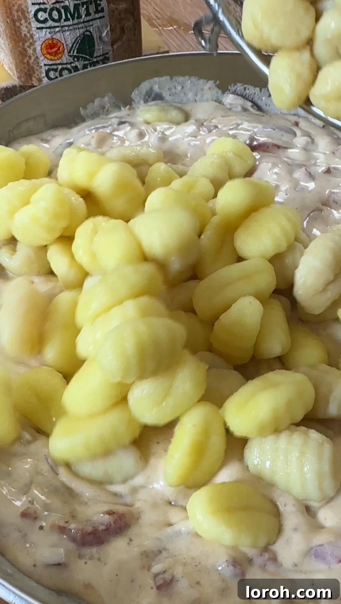 Step five: Combining gnocchi, sauce, and Comté cheese.