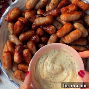 Honey Mustard Sausages in a plate with a dipping sauce.