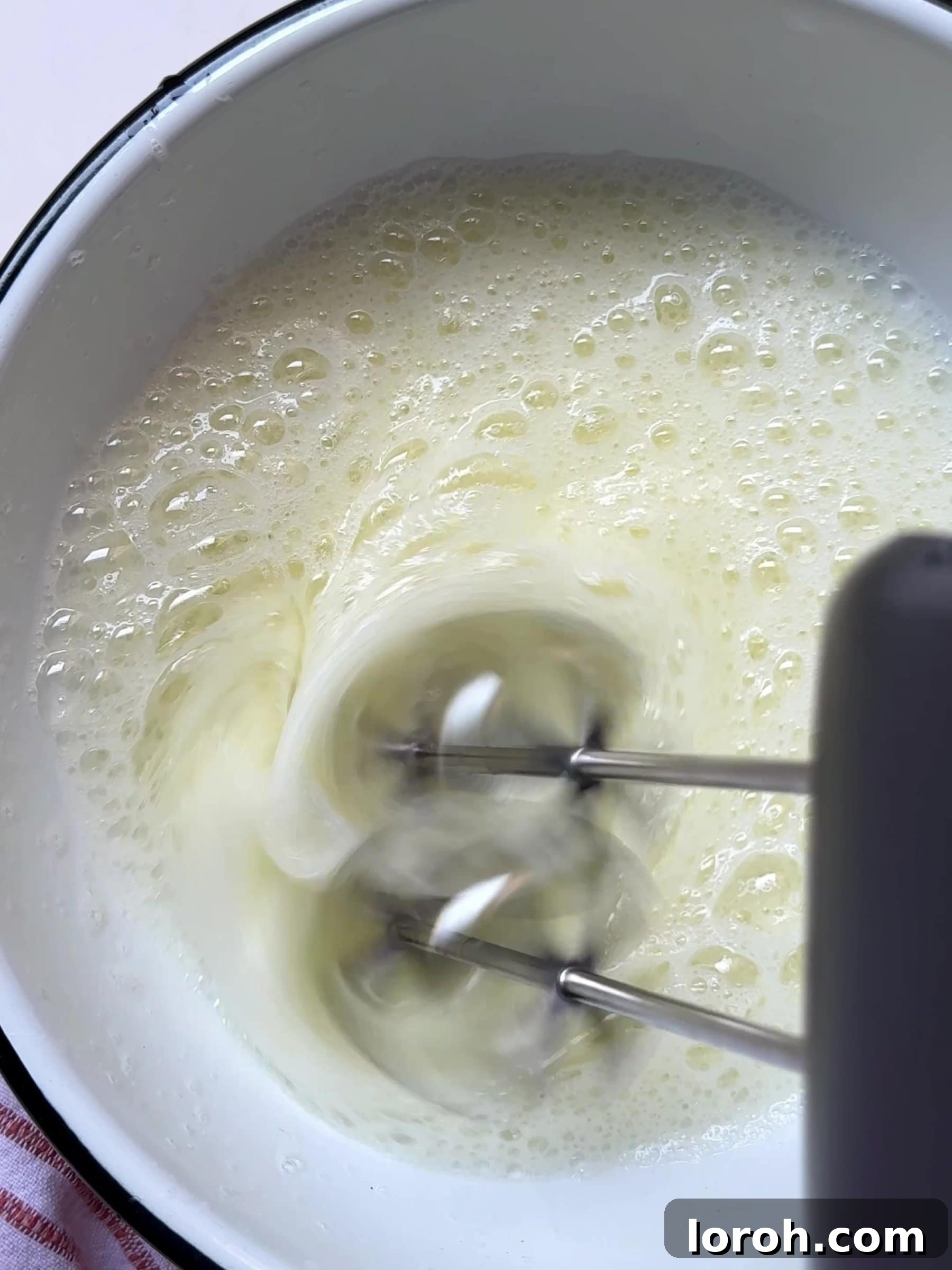 Holiday Spiced Pear Cloud 10 Mixing egg white with an electric whisk.
