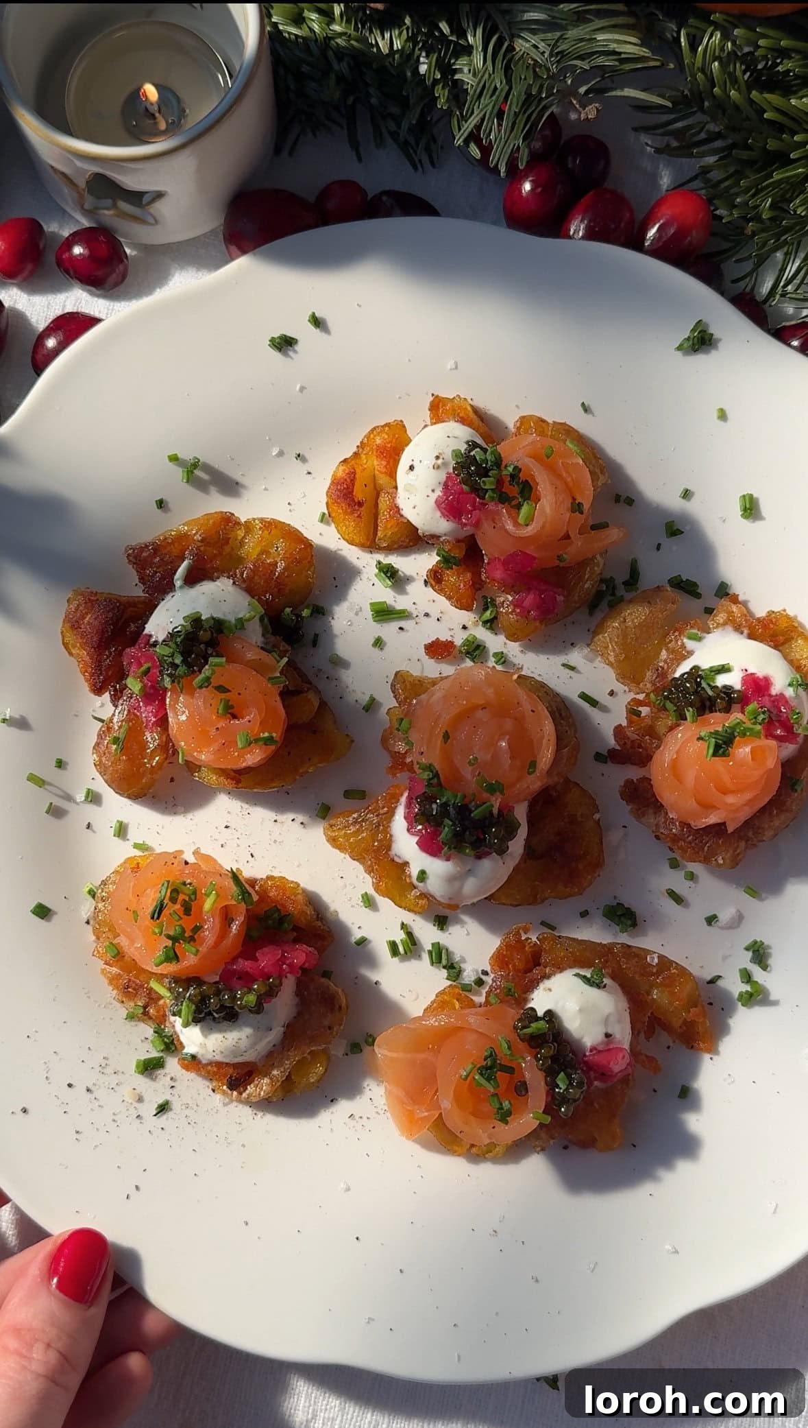 A beautifully arranged platter of Smashed Potatoes with Crème Fraîche and smoked salmon, garnished with chives.