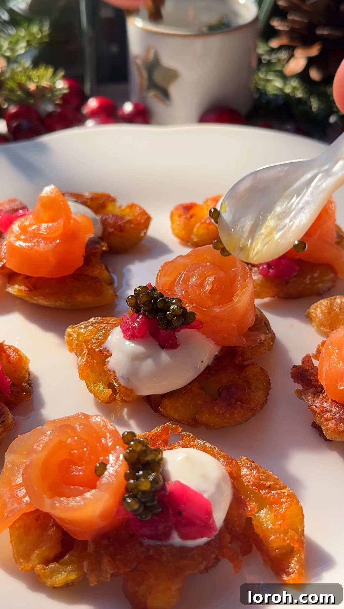 Finished smashed potatoes with crème fraîche, smoked salmon, caviar, and a sprinkle of chives.