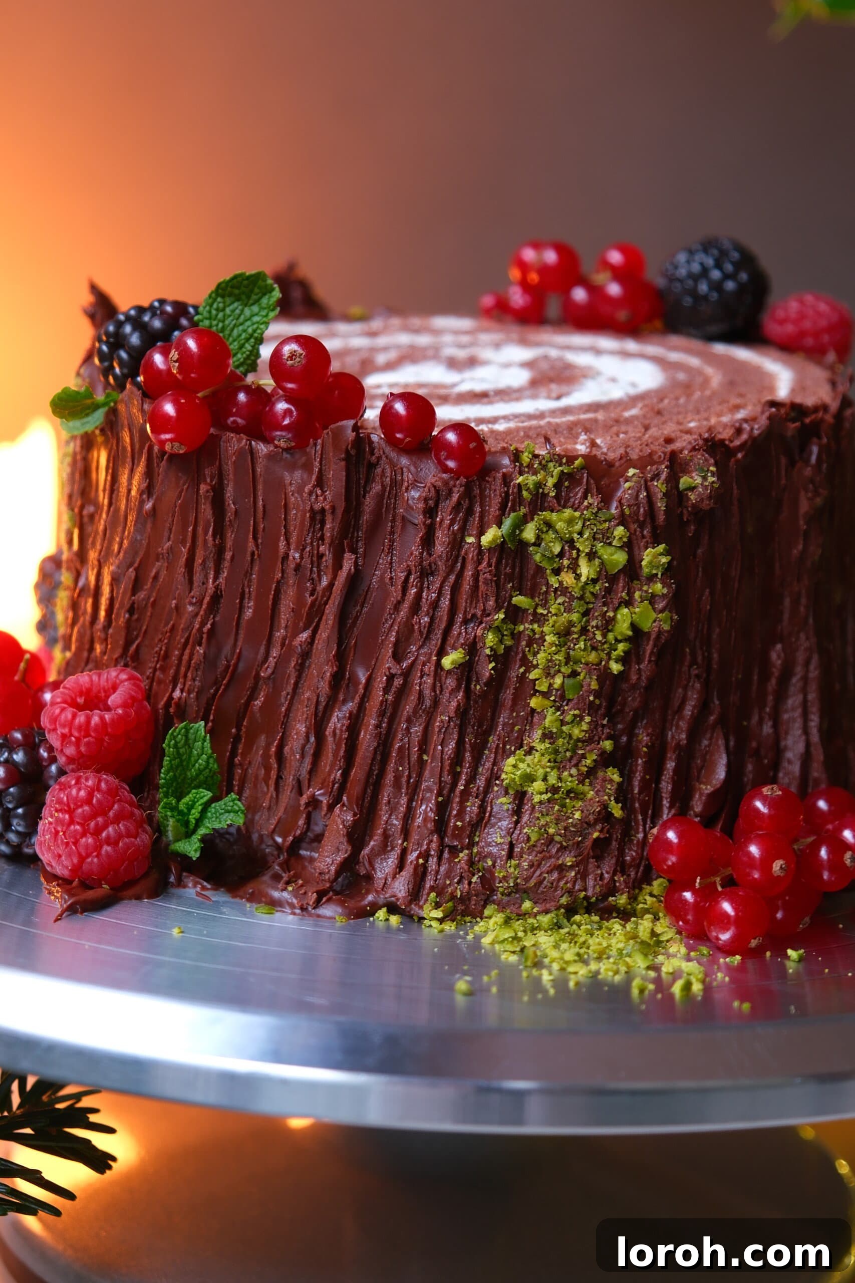 Winter Woodland Roll 21 buche de noel on a plate with berries.